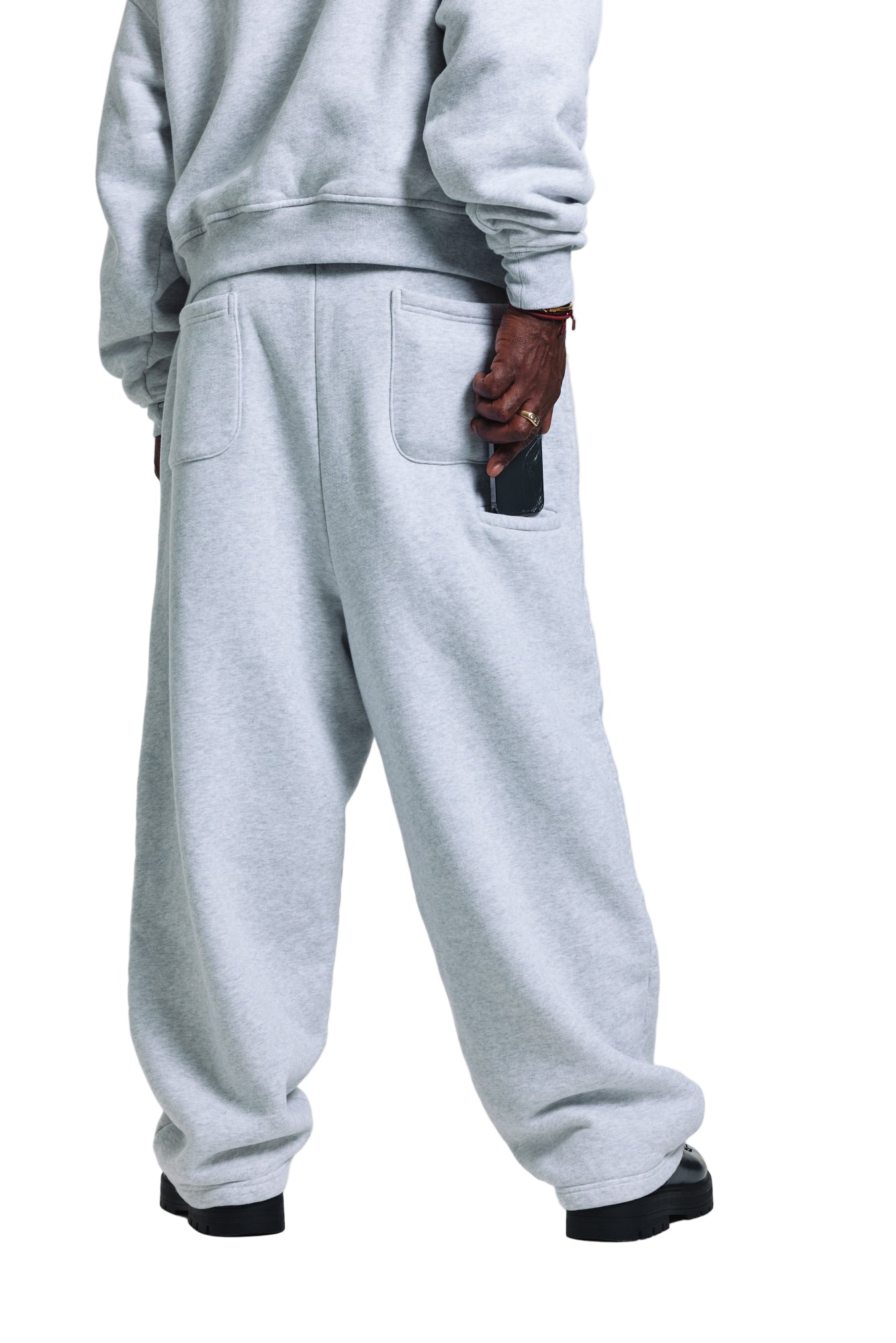 Person wearing gray sweatpants on a white background